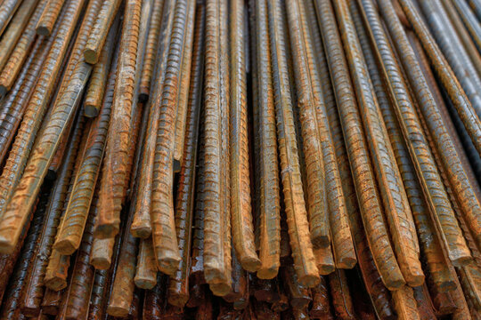 Stack of rusty iron rods or bars. Old metal rusty or steel rod.