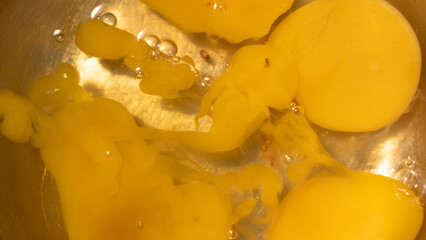 broken and smeared yolks abstraction. cooking or baking backdrop. orange background for recipes. egg texture