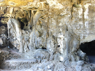 The cave is made of stone. Walls, floor and ceiling made of stone. All grey with yellow spots, Aruba, Nature cave, August 2014
