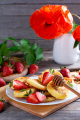 Cottage cheese pancakes, syrniki with fresh berries for breakfast.