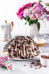 Chocolate sponge cake with cream and a cup of coffee