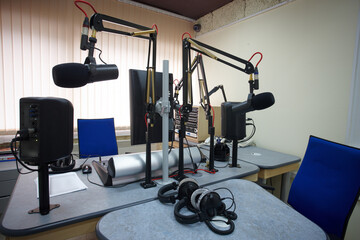 Fototapeta na wymiar microphones and headphones for radio presenters in the radio room