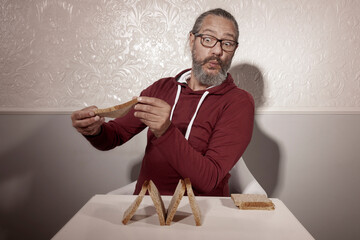 elderly man plays with bread