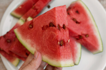 Red watermelon triangular piece on white background