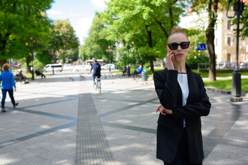 Young woman talking on a cell phone while walking around the city