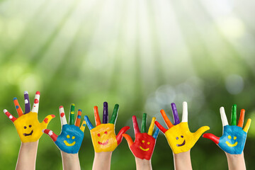 School holidays. Children with painted palms outdoors, closeup