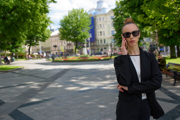 Young woman talking on a cell phone while walking around the city