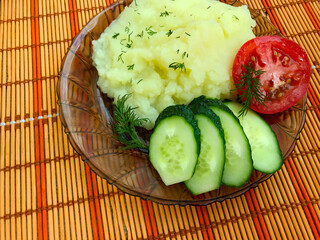 Mashed potatoes on a transparent brown plate.