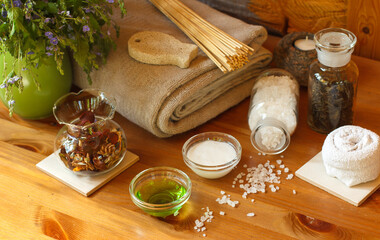 Bath accessories and a pitcher of wild flowers on a wooden table