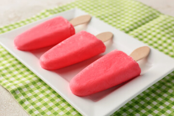 Plate with tasty strawberry ice cream on table