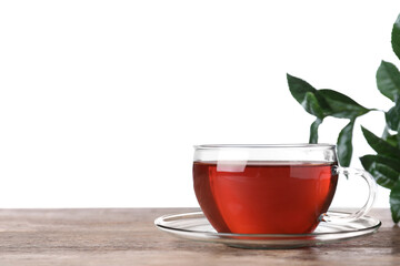 Glass cup of aromatic black tea on wooden table against white background. Space for text
