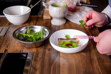 Chef decorates a peas, horse meat and kimchi sauce. Master class in the kitchen. The process of cooking. Step by step. Tutorial. Close-up