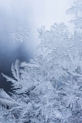 Nice frost pattern on glass in cold temperature colors for summer heat, abstract background