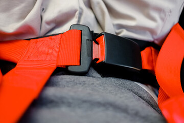 Close-up view of red sports seat belt. Racing car interior. © Евгений Гвоздев