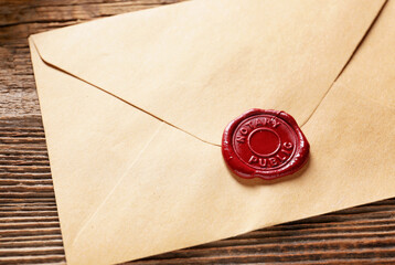 Envelope with notary public wax seal on table, closeup