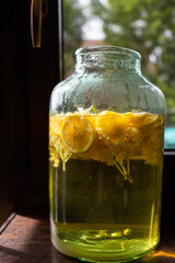 homemade syrup of elderberry flowers in a glass jar