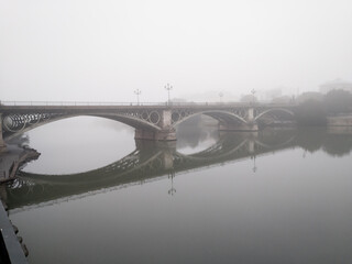 Naklejka premium The river Guadalquivir as seen from Triana in a foggy day