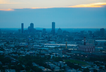 Fototapeta premium City of Boston, Massachusetts, United States of America at sunset, photo taken at sunset, some buildings are visible on the horizon.