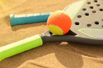 Beach tennis rackets in sand, summer beach sport 