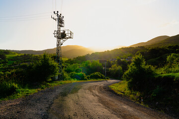 View a village in sunset with electric transformer near the road, Kizilcahamam, Ankara, Turkey