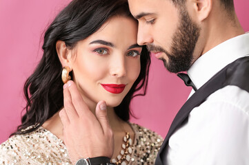 Naklejka premium Young couple wearing stylish accessories on color background