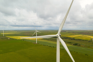 Aerial view of wind turbines in field on cloudy day