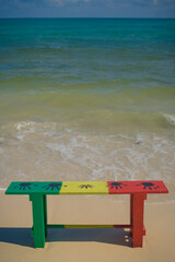 Fototapeta na wymiar Reggae bench in Caribbean beach, Rasta