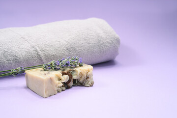 Fototapeta na wymiar A soap bar and lavender and towel on the grey background.