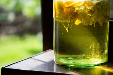 homemade syrup of elderberry flowers in a glass jar