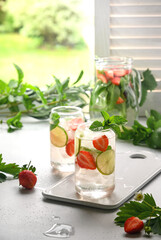 Freshness lemonade with strawberries and lime. Homemade beverage. Vertical orientation. Rustic summer morning.