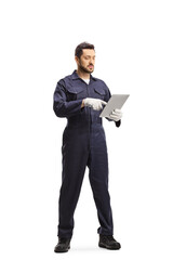 Full length portrait of an auto mechanic using a tablet