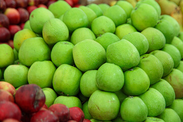 Fresh green sour apples in a market