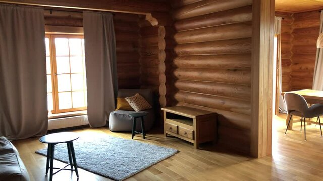 Interior of a wooden house made of larch timber. Cozy room of a country cottage