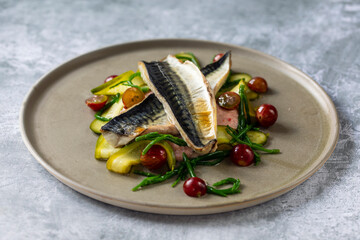 Grilled mackerel with gooseberry ketchup, pickled cucumber and whole gooseberries and samphire