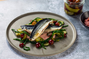 Grilled mackerel with gooseberry ketchup, pickled cucumber and whole gooseberries and samphire