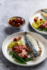 Grilled mackerel with gooseberry ketchup, pickled cucumber and whole gooseberries and samphire