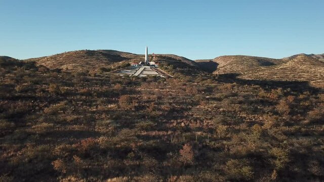 4K aerial drone video of African savanna hills, Heroes Acre memorial complex near B1 highway south of Windhoek in central highland Khomas Hochland of Namibia, southern Africa