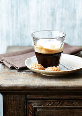 Coffee with milk on rustic wooden background.