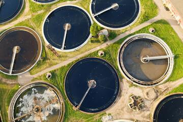 Round tanks for wastewater filtration in sewage treatment plants, aerial view.