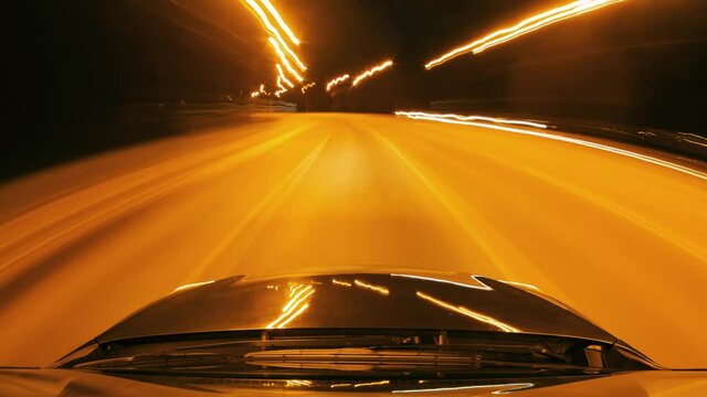 Time lapse of driving a car in the city at night. Camera on the roof of the car. Hyperlapse in the evening in the center of the city on the highway. Abstract soft glowing lines.