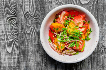 Fresh rustic vegetable salad on rustic background