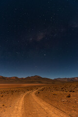 Fototapeta na wymiar Vertical landscape at night of the North Lipez desert in the Andes mountains with the milky way galaxy near the Uyuni Salt Flat Desert, Bolivia.