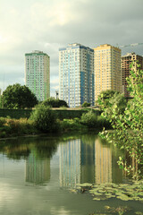 Building a house near the water in the park. Cityscapes with beautiful forest and trees. Stock photo background.