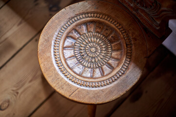 Wooden hand carved old chairs in the open-air museum