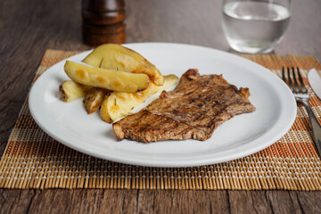 Narrow beef steak with potatoes and rocket salad and cherry tomatoes