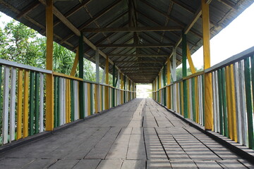 OLD WOODEN BRIDGE IN THE MIDDLE OF THE COLOMBIAN AMAZON