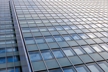 Close up detail of reflected glass facade with rectangular windows grid frame system of modern office building. Abstract Architectural Geometry elements background with urban metropolis concept.