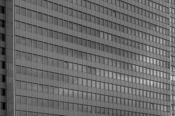 Black and white tone, Close up detail of modern glass facade with rectangular windows frame system of office building. Abstract Architectural Geometry elements with urban metropolis concept.