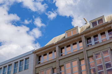 Low angle view of the top of exterior typical modern architecture and building in city of Europe with detail of windows facade and skylight on rooftop. 