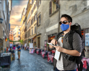 Tourist/Backpacker with face mask looking for an address on the map